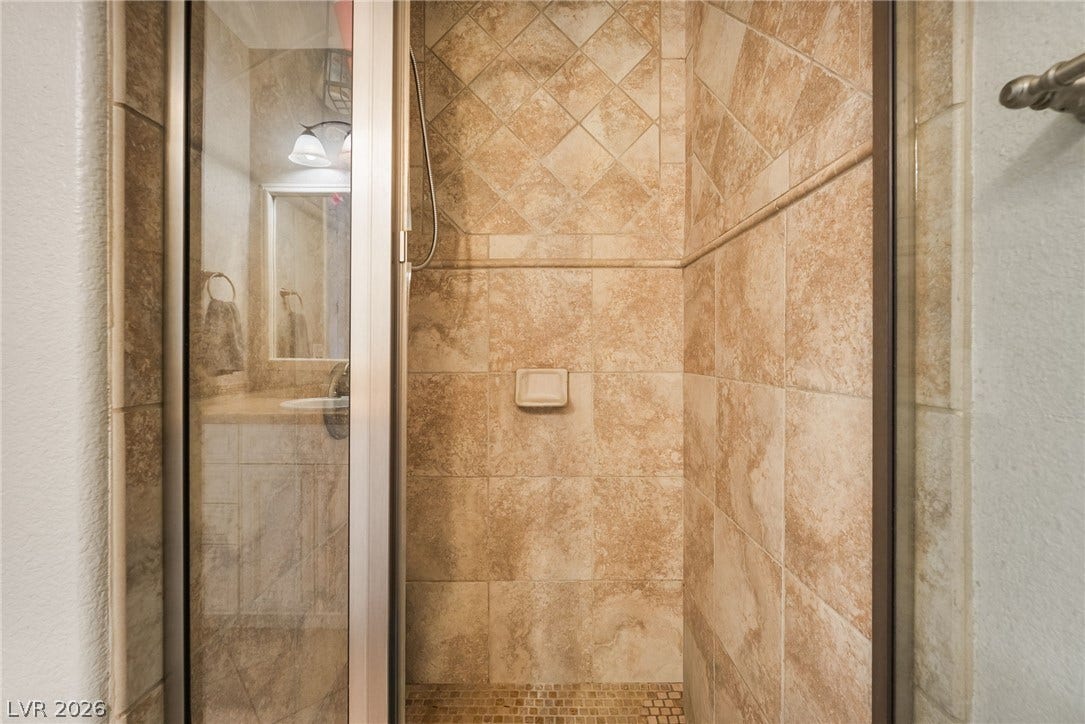 30 Via Vasari, #103, Henderson, NV 89011 Textured tile surrounds the walk-in shower, complete with glass door entry.