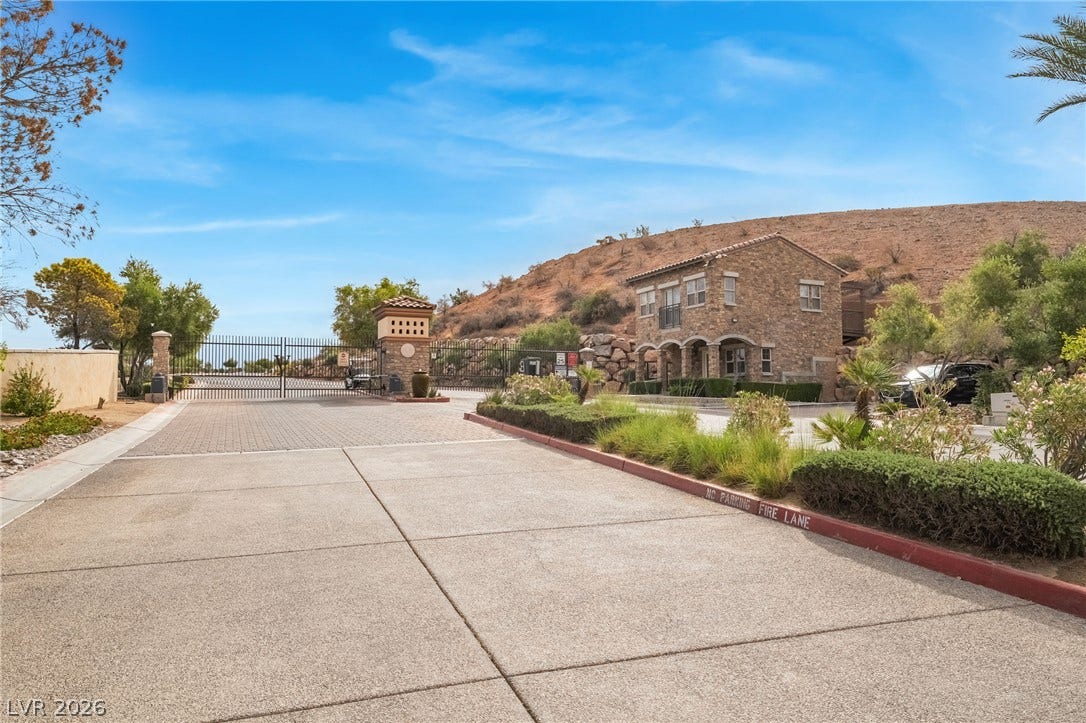 30 Via Vasari, #103, Henderson, NV 89011 A secure gated entrance welcomes residents with stone-accented architecture and professional landscaping.