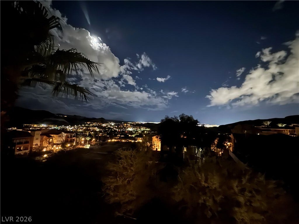30 Via Vasari, #103, Henderson, NV 89011 Glimmering city lights and rolling hills define the sweeping nighttime panorama from this property.