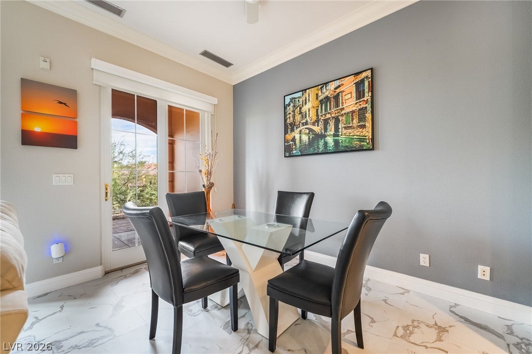 30 Via Vasari, #103, Henderson, NV 89011 crown molding highlight this welcoming dining space with patio access.
