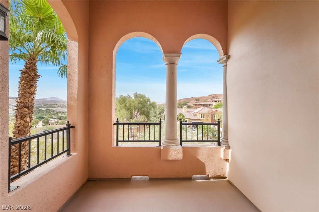30 Via Vasari, #103, Henderson, NV 89011 Classical arched openings frame scenic neighborhood views from this elevated stucco balcony.