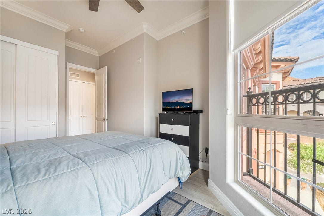30 Via Vasari, #103, Henderson, NV 89011 Crisp crown molding and large windows frame this bedroom overlooking a quiet courtyard.