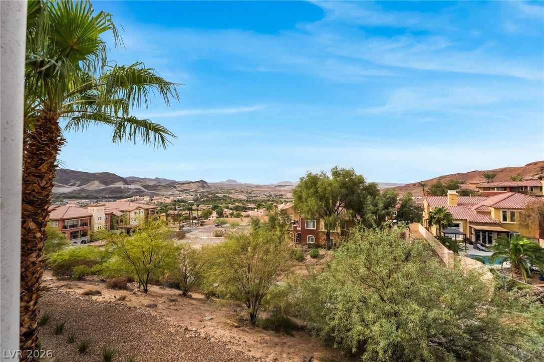 30 Via Vasari, #103, Henderson, NV 89011 Sweeping desert vistas look out over the surrounding neighborhood under open blue skies.