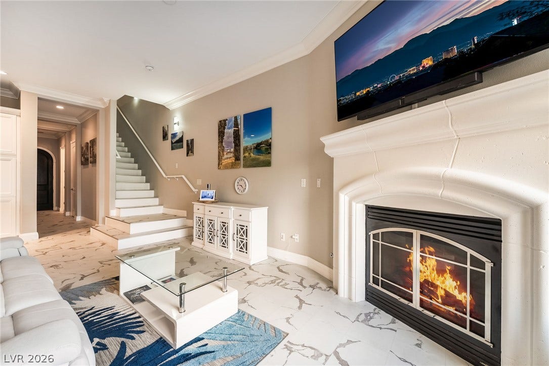 30 Via Vasari, #103, Henderson, NV 89011 open living space anchored by a classic fireplace.