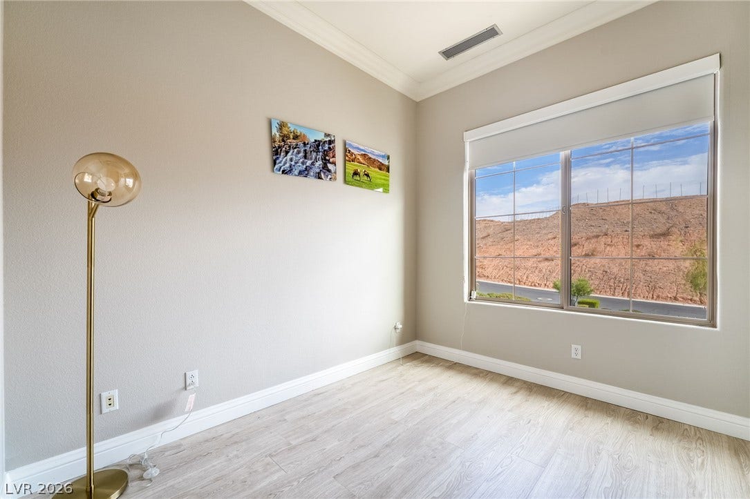 30 Via Vasari, #103, Henderson, NV 89011 High ceilings and clean molding frame a window offering elevated hillside views.