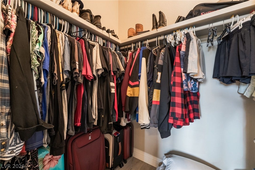 30 Via Vasari, #103, Henderson, NV 89011 Ample built-in shelving and hanging rods maximize storage capacity in this organized walk-in closet.