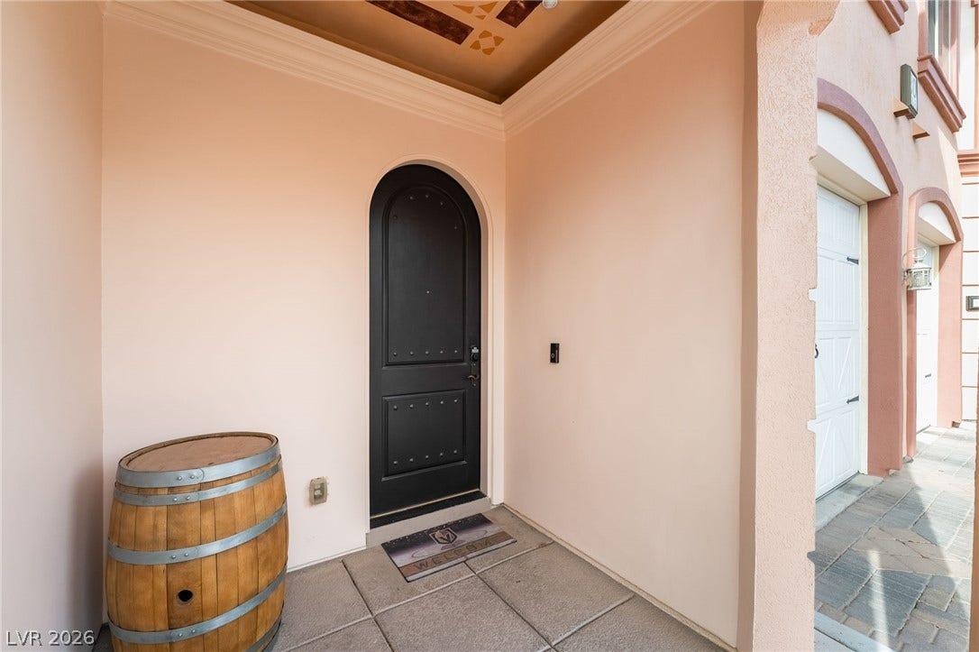 30 Via Vasari, #103, Henderson, NV 89011 An arched entry door welcomes guests under a detailed tray ceiling.