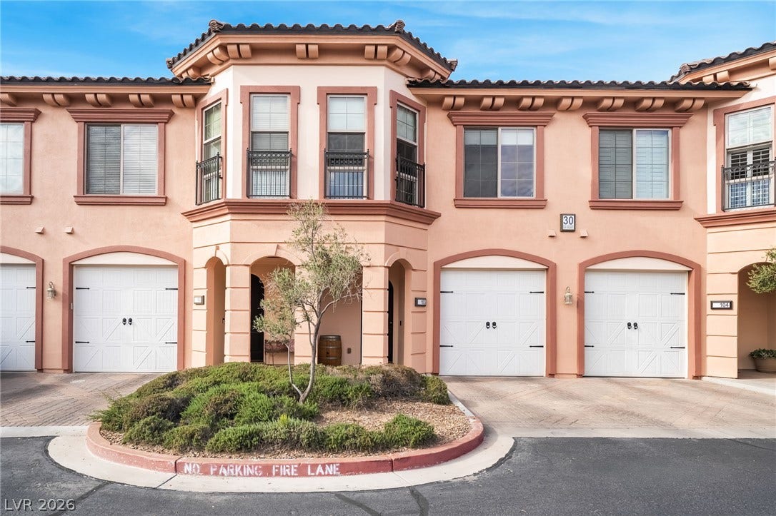 30 Via Vasari, #103, Henderson, NV 89011 Mediterranean architectural styling defines the exterior of this multi-level residential building.