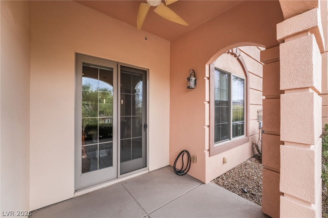 30 Via Vasari, #103, Henderson, NV 89011 Concrete flooring and elegant stucco arches define this sheltered outdoor patio space.