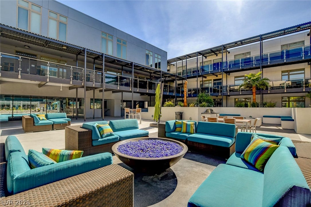 8925 W Flamingo Road, #111, Las Vegas, NV 89147 An expansive concrete courtyard features an outdoor lounge area surrounding a central fire pit.