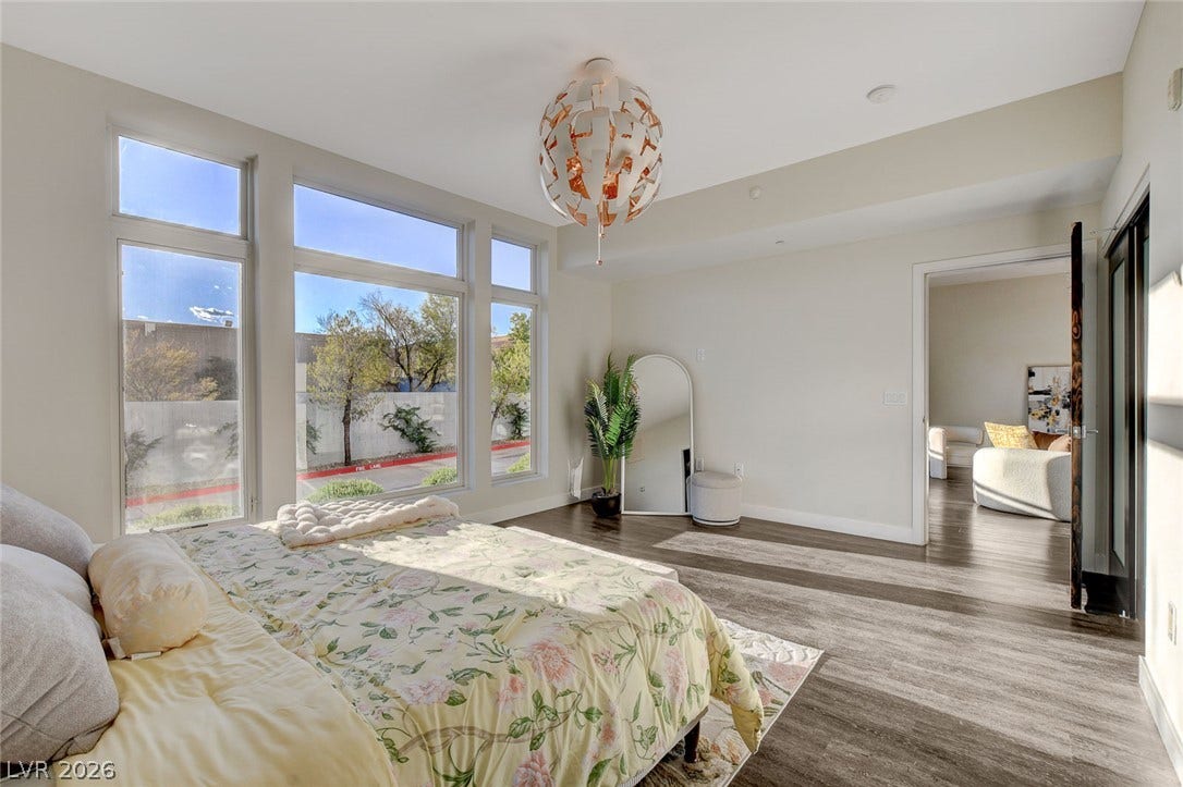 8925 W Flamingo Road, #111, Las Vegas, NV 89147 Sleek hardwood flooring and towering windows define this modern sleeping space.