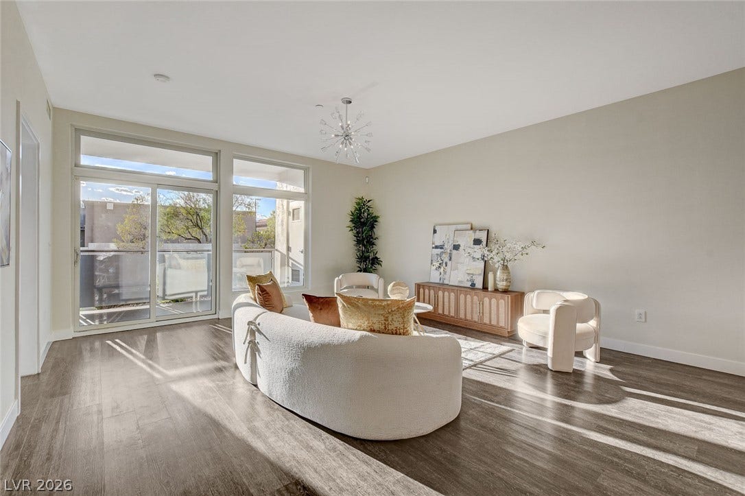8925 W Flamingo Road, #111, Las Vegas, NV 89147 Gleaming hardwood floors and a modern lighting fixture elevate this sunlit living space.