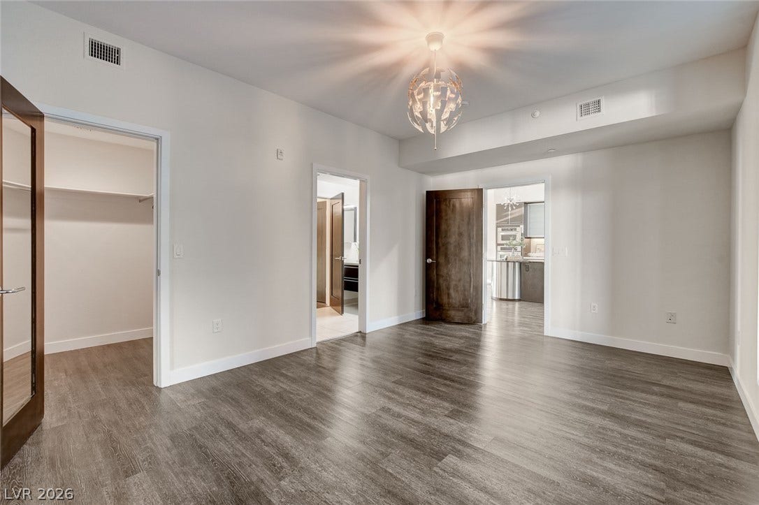 8925 W Flamingo Road, #111, Las Vegas, NV 89147 Rich wood flooring and sleek solid doors anchor this versatile, airy interior layout.