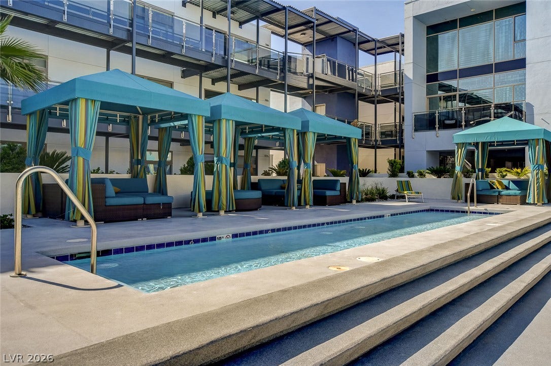 8925 W Flamingo Road, #111, Las Vegas, NV 89147 Step down to a sparkling swimming pool lined with covered cabanas and modern structural design.
