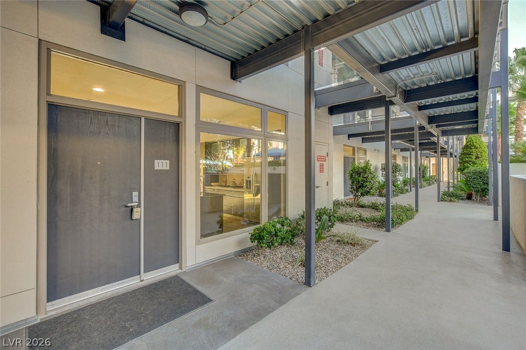 8925 W Flamingo Road, #111, Las Vegas, NV 89147 Industrial architectural elements frame the covered walkway leading to this modern private entrance.