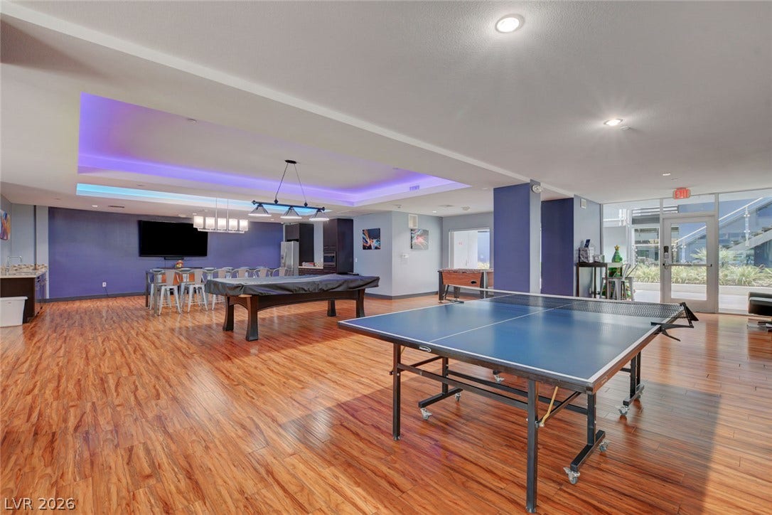 8925 W Flamingo Road, #111, Las Vegas, NV 89147 Rich wood flooring runs throughout this spacious recreation room featuring a stylish recessed ceiling design.