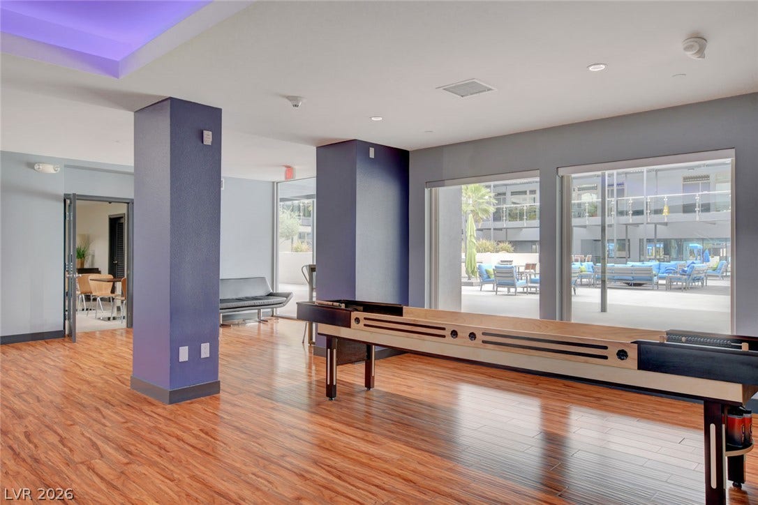 8925 W Flamingo Road, #111, Las Vegas, NV 89147 Rich wood floors and recessed lighting enhance this modern community game room.
