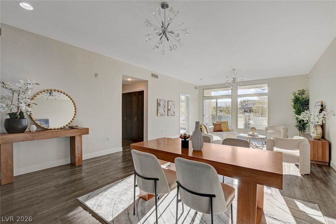 8925 W Flamingo Road, #111, Las Vegas, NV 89147 Rich wood-look flooring and tall glass doors anchor this airy, open-concept dining area.