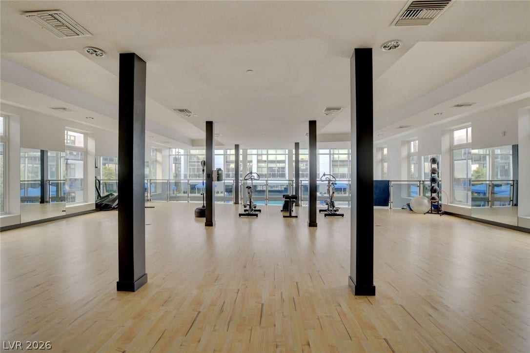 8925 W Flamingo Road, #111, Las Vegas, NV 89147 Gleaming hardwood floors and striking support columns anchor a spacious fitness studio lined with mirrors.