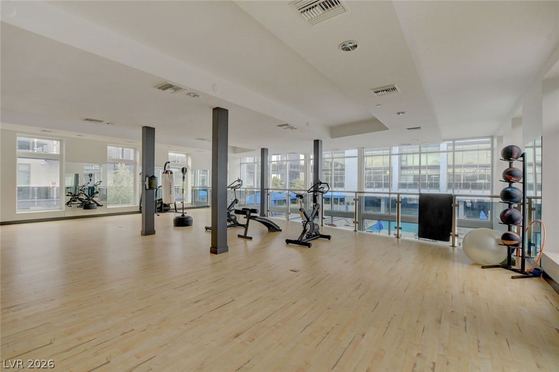 8925 W Flamingo Road, #111, Las Vegas, NV 89147 Polished hardwood floors and floor-to-ceiling windows create a bright, airy exercise space.