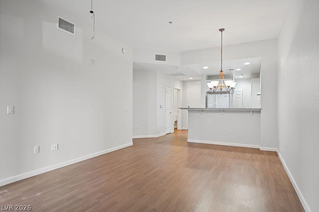 47 E Agate Avenue, #301, Las Vegas, NV 89123 Gleaming wood floors anchor an airy interior plan integrating living and kitchen spaces.