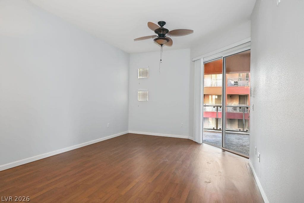 47 E Agate Avenue, #301, Las Vegas, NV 89123 Rich wood flooring anchors this inviting space, complete with sliding glass doors opening to a balcony.