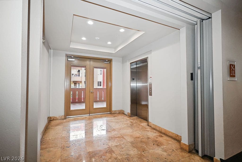 47 E Agate Avenue, #301, Las Vegas, NV 89123 Polished stone flooring and recessed lighting define this elegant elevator lobby area.
