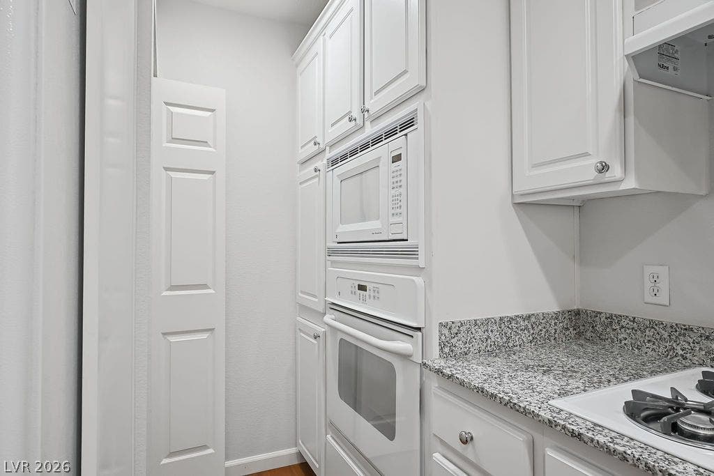 47 E Agate Avenue, #301, Las Vegas, NV 89123 Stone countertops and classic built-in cabinetry maximize storage and functionality in this space.