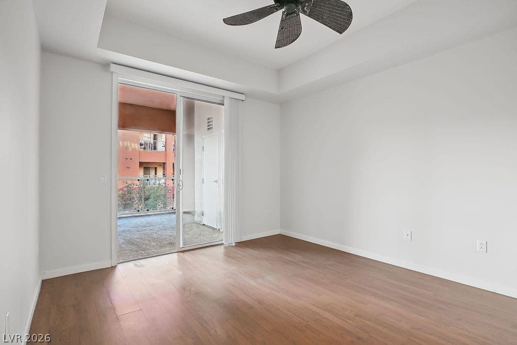 47 E Agate Avenue, #301, Las Vegas, NV 89123 Warm wood flooring and a recessed tray ceiling define this inviting room with balcony access.