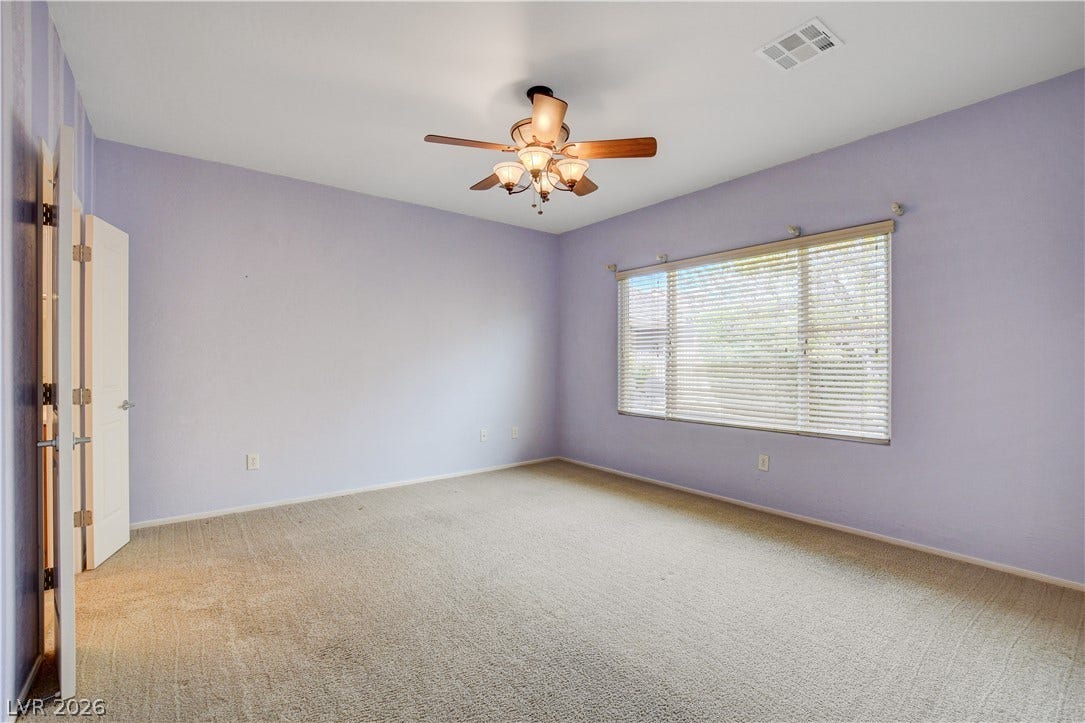 2612 Rock Pigeon Avenue, North Las Vegas, NV 89084 Soft wall tones complement the plush carpeting and wide window in this inviting bedroom.