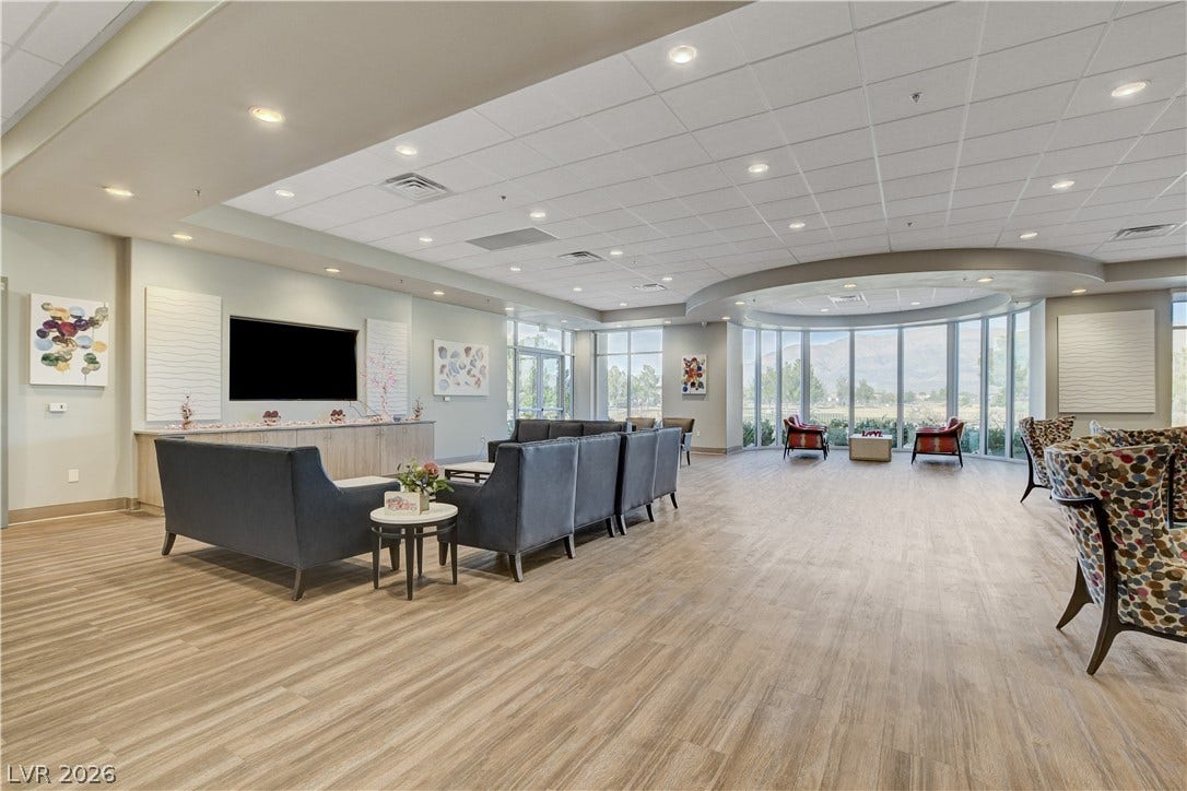 2612 Rock Pigeon Avenue, North Las Vegas, NV 89084 A curved wall of windows illuminates the spacious community room with natural light.
