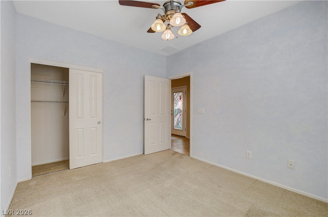 2612 Rock Pigeon Avenue, North Las Vegas, NV 89084 Soft carpeting pairs with neutral walls to create a comfortable and versatile bedroom space.