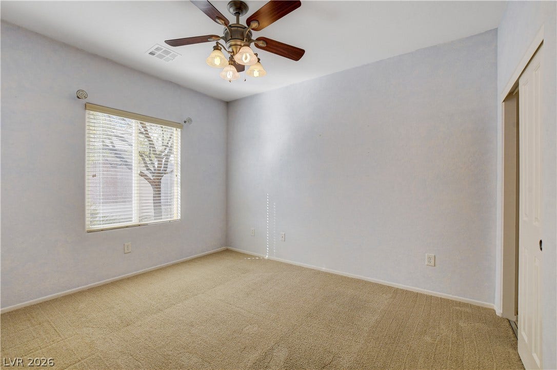 2612 Rock Pigeon Avenue, North Las Vegas, NV 89084 Soft carpeting pairs with a wide window framing peaceful outdoor views.
