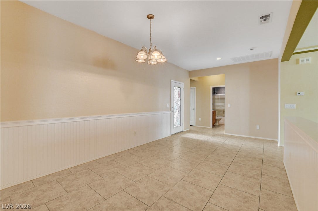 2612 Rock Pigeon Avenue, North Las Vegas, NV 89084 Durable tile floors and wainscoted walls anchor this versatile dining area near the entryway.