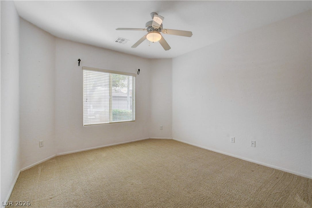 2612 Rock Pigeon Avenue, North Las Vegas, NV 89084 Plush carpeting and a wide window create a comfortable, inviting atmosphere.