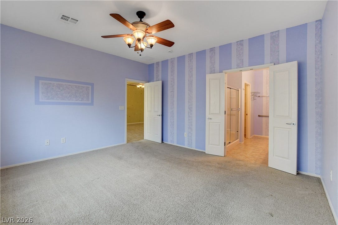 2612 Rock Pigeon Avenue, North Las Vegas, NV 89084 Plush carpeting and an en-suite layout define this versatile bedroom space.