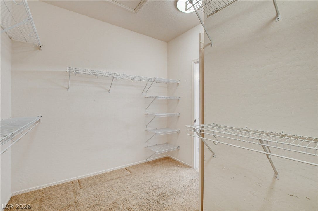 2612 Rock Pigeon Avenue, North Las Vegas, NV 89084 Ample wire shelving and soft carpeting maximize storage potential in this walk-in closet.