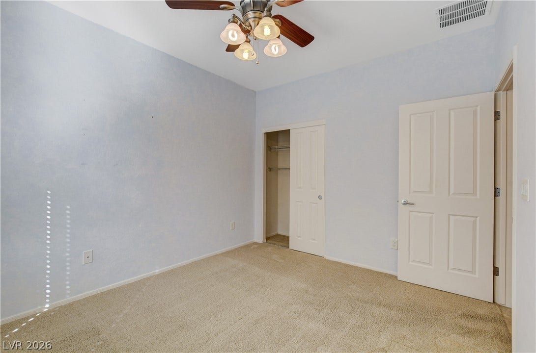 2612 Rock Pigeon Avenue, North Las Vegas, NV 89084 Plush carpeted flooring anchors this quiet bedroom space.