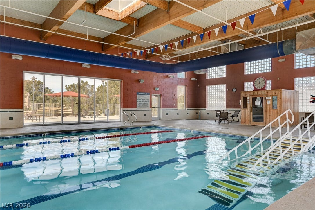 2612 Rock Pigeon Avenue, North Las Vegas, NV 89084 Exposed wood beams and massive glass doors accent this expansive indoor pool facility.