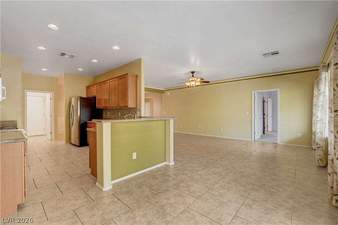 2612 Rock Pigeon Avenue, North Las Vegas, NV 89084 An open floorplan seamlessly connects the kitchen to the main living areas over tiled flooring.