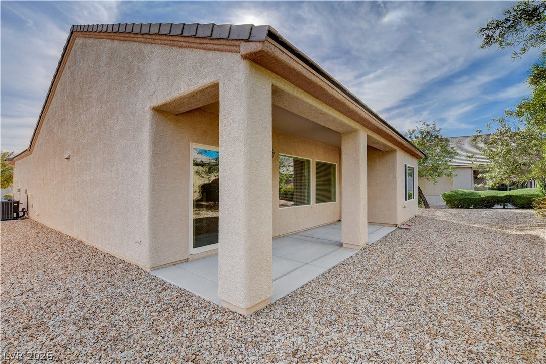 2612 Rock Pigeon Avenue, North Las Vegas, NV 89084 A covered concrete patio runs along the side of this low-maintenance stucco home.