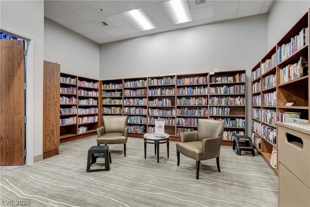 2612 Rock Pigeon Avenue, North Las Vegas, NV 89084 Extensive built-in bookcases wrap around this quiet library space with patterned flooring.
