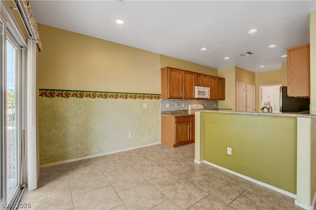 2612 Rock Pigeon Avenue, North Las Vegas, NV 89084 Tiled flooring and recessed lighting connect the casual dining space to the kitchen.
