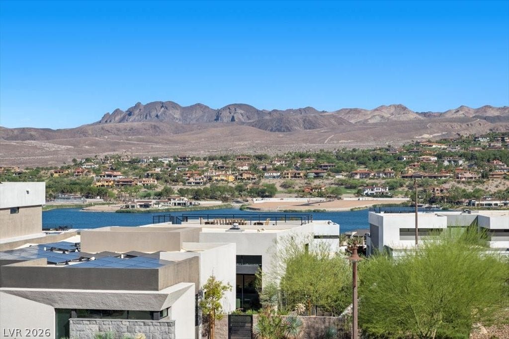 5 HIGHLAND COVE Lane, Henderson, NV 89011 This elevated view captures modern architecture, lake vistas, and distant mountains.