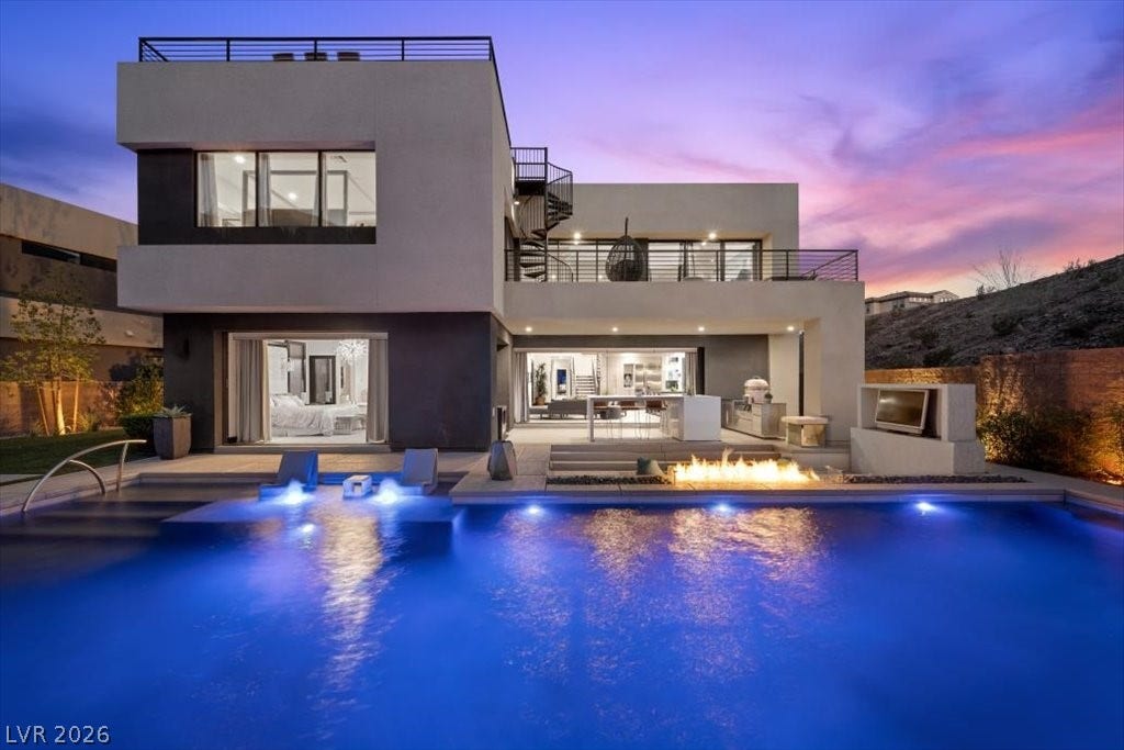 5 HIGHLAND COVE Lane, Henderson, NV 89011 This modern residence offers an inviting exterior with a sparkling pool, outdoor kitchen, and captivating fire pit.