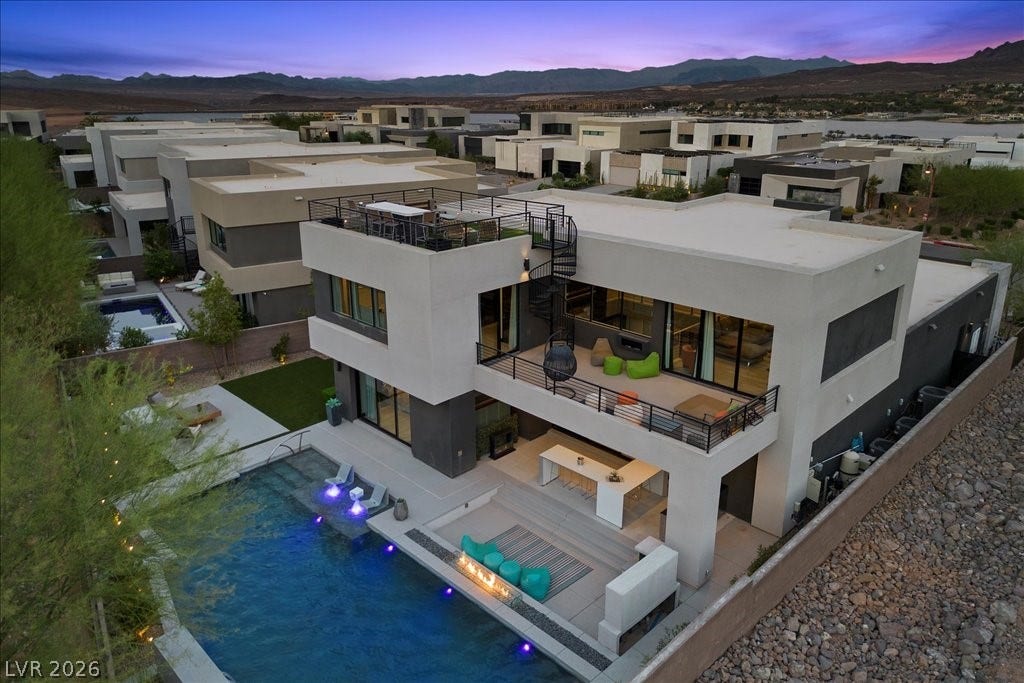 5 HIGHLAND COVE Lane, Henderson, NV 89011 This contemporary home boasts multiple outdoor living areas and a refreshing pool, perfect for entertaining.