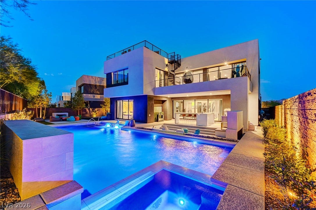 5 HIGHLAND COVE Lane, Henderson, NV 89011 A contemporary multi-level backyard oasis features sleek stucco lines, a custom pool, and integrated outdoor living spaces.