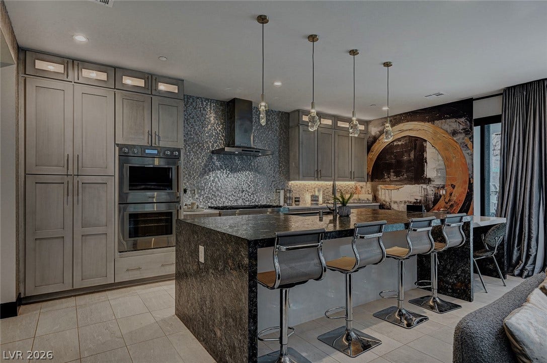 5 HIGHLAND COVE Lane, Henderson, NV 89011 Premium stone countertops and sleek cabinetry elevate this culinary space.