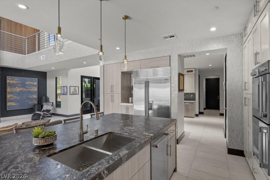 5 HIGHLAND COVE Lane, Henderson, NV 89011 This kitchen showcases a modern aesthetic with functional design and high-end finishes.