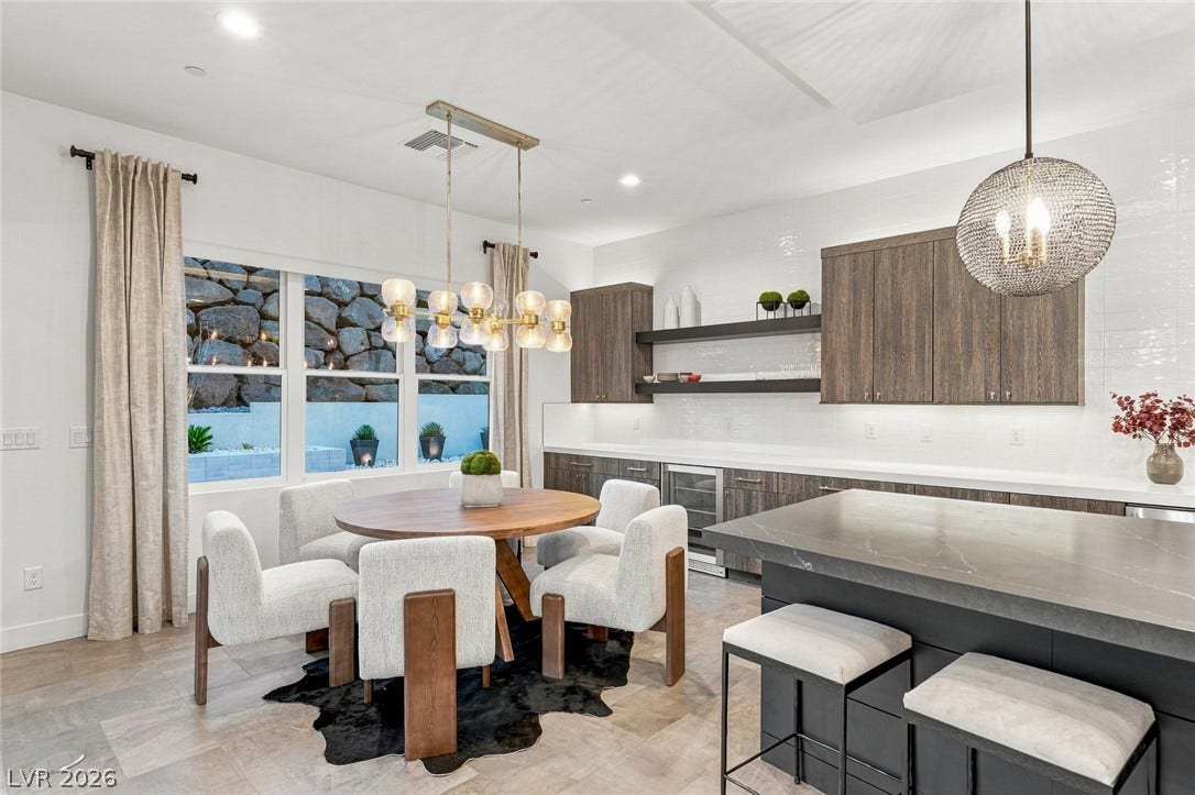 Gleaming stone countertops and warm wood cabinets define this modern open-concept space.